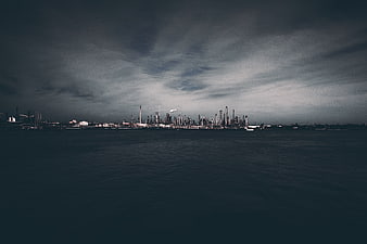 Dark Industrial Refinery Skyline Over Water