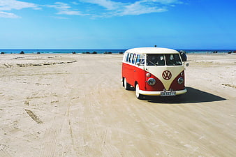 Vintage Red and White VW Camper Van on Sandy Beach