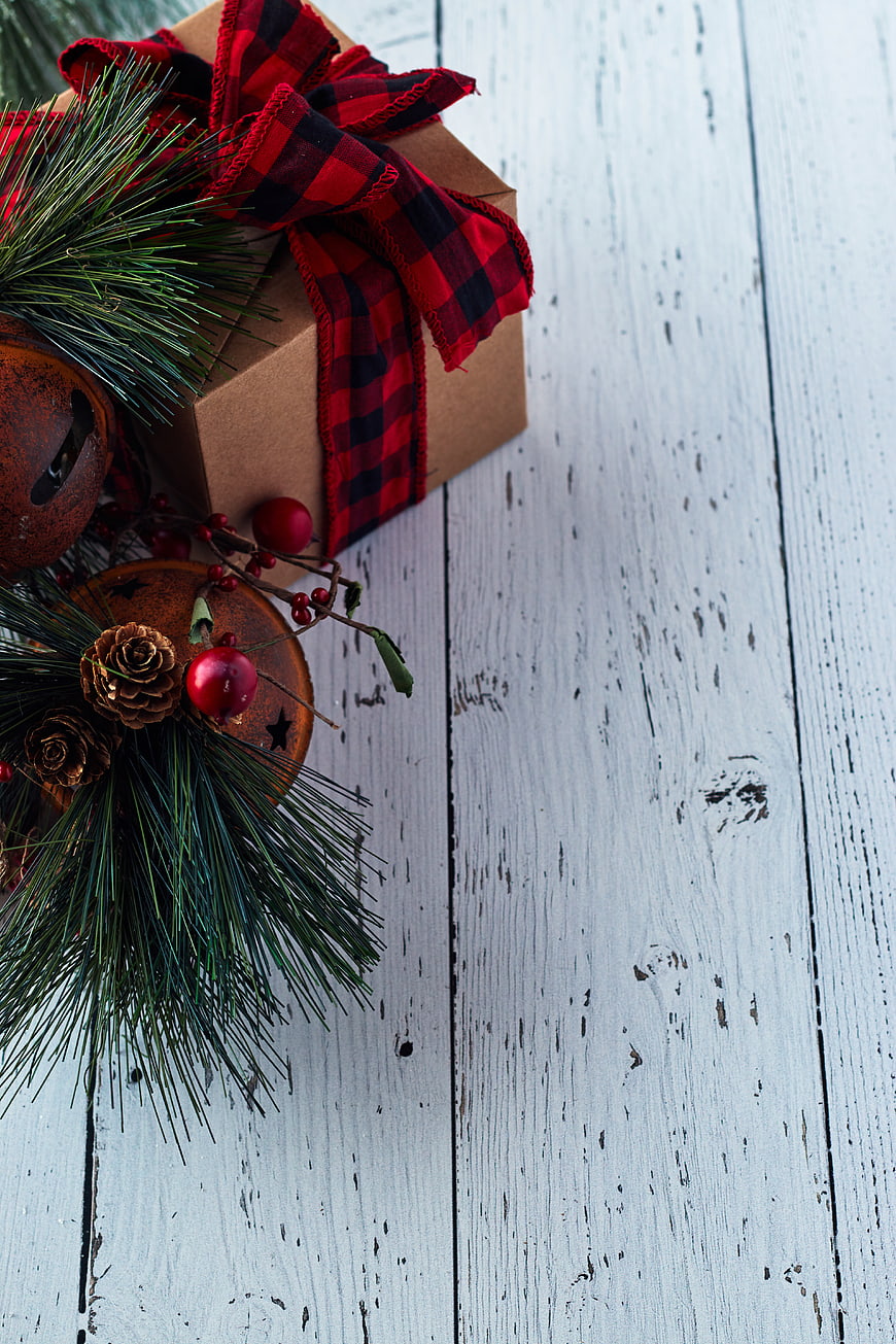 Christmas Gift Box with Plaid Ribbon on White Wood