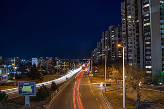 Night Cityscape with Long Exposure Light Trails on Highway