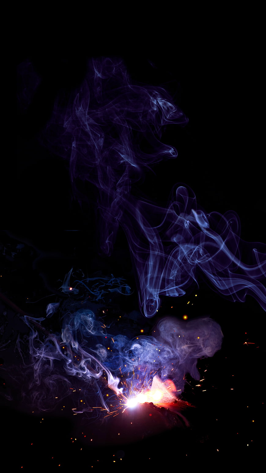 Abstract Purple Smoke and Orange Sparks on Black Background