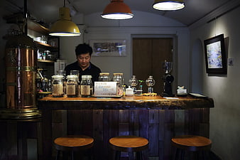 Barista Behind Rustic Coffee Shop Counter