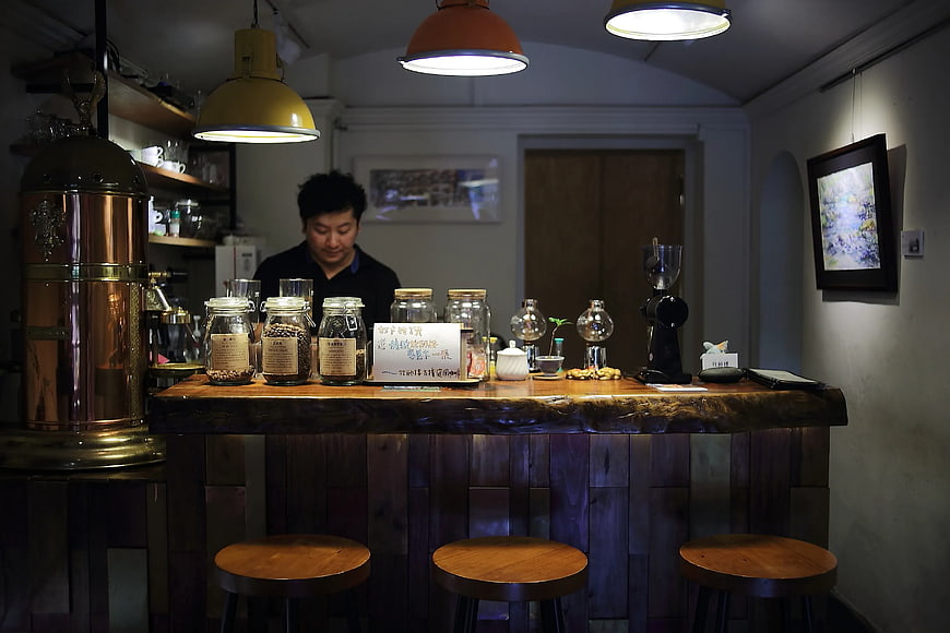 Barista Behind Rustic Coffee Shop Counter