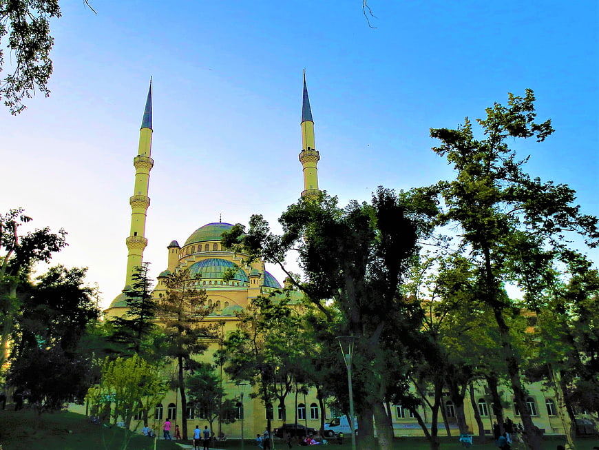 Yellow Mosque with Minarets and Green Dome in Park