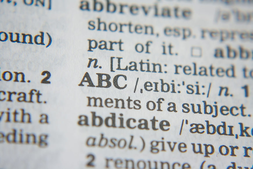 Close-up of dictionary page with word ABC and definitions