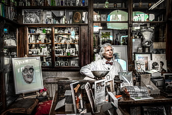 Man in White Coat Sitting in Cluttered Antique Shop