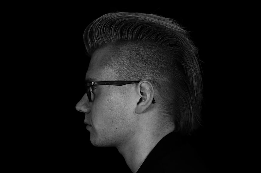 Side Profile of Man with Pompadour Haircut and Glasses