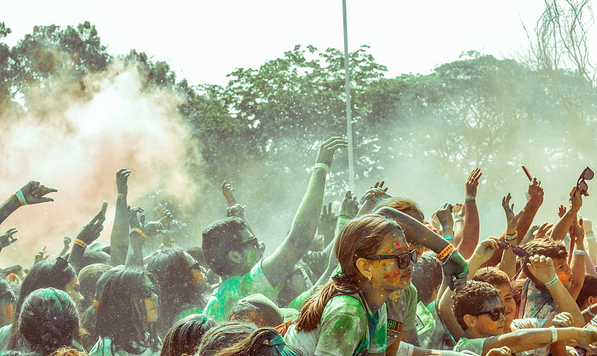 Crowd Celebrating Holi Festival With Colorful Powder