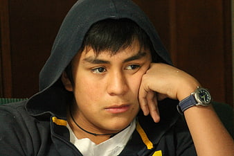 Pensive Teenage Boy Wearing Hoodie And Watch