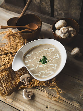 Creamy Mushroom Soup in White Bowl on Rustic Wood