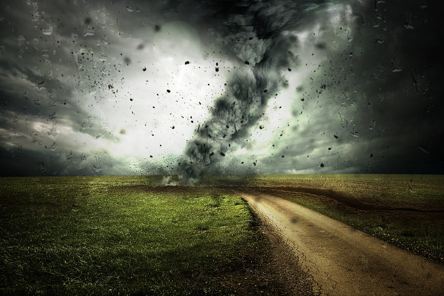 Dramatic Tornado Touching Down In Green Field With Dirt Road