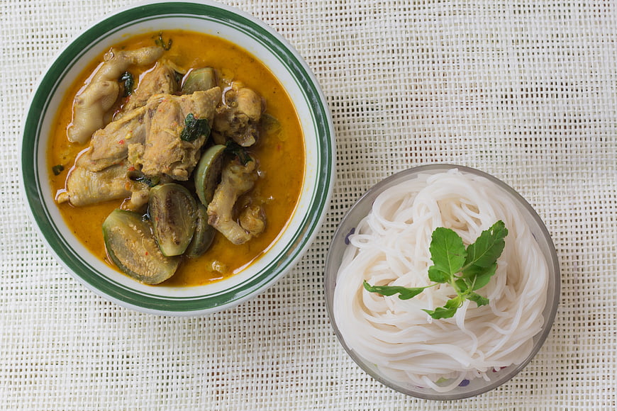 Overhead view of Thai green chicken curry with rice noodles