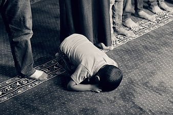 Young Muslim Boy Prostrating in Prayer at Mosque