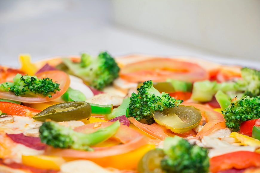 Close-up of vegetable pizza with broccoli and peppers
