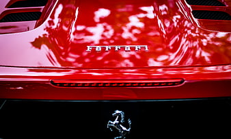 Close-up of red Ferrari rear with prancing horse emblem