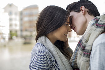 Romantic couple touching foreheads outdoors in winter