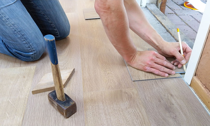 Carpenter Measuring Laminate Flooring Installation