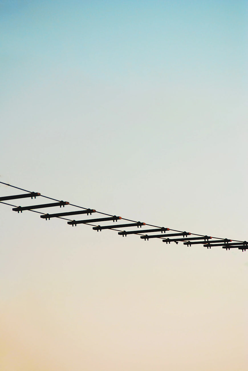 Black Rope Ladder Silhouette Against Gradient Sky