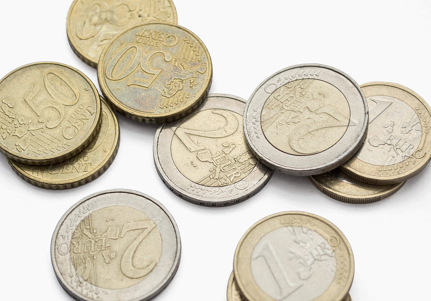 Scattered Euro Coins Including 50 Cent and 2 Euro on White Background