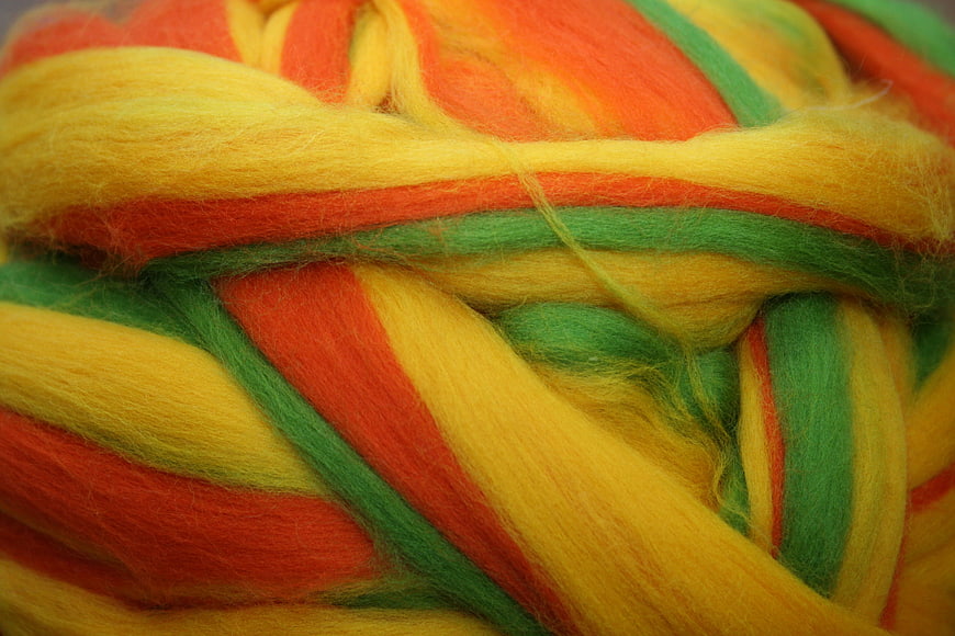 Close-up of multicolored wool yarn in red, yellow, and green