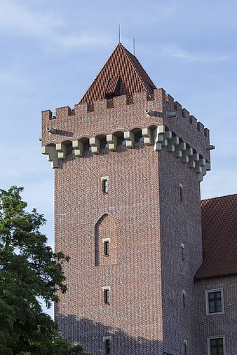 Red Brick Castle Tower with Crenellations and Tiled Roof