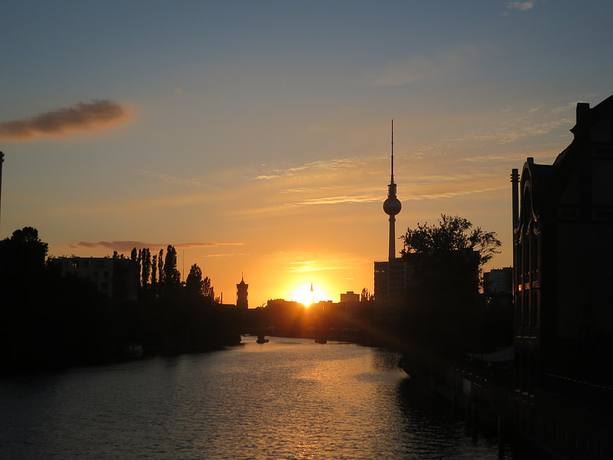 Berlin TV Tower Silhouette at Sunset Over River