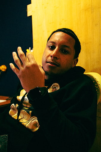 Portrait of young man in black hoodie gesturing hand