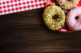 Colorful Glazed Donuts on Red Plate with Checkered Cloth