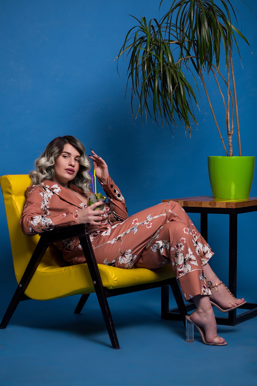 Stylish Woman in Floral Suit Relaxing with Cocktail