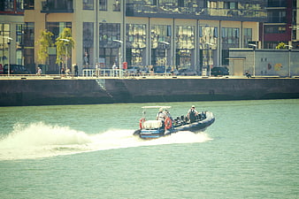 Rigid Inflatable Boat Speeding on Urban Waterway