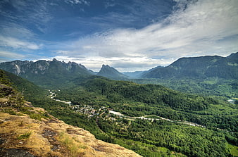 Panoramic Alpine Valley with Forest and Distant Peaks