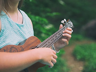 Woman Playing Ukulele Outdoors in Nature
