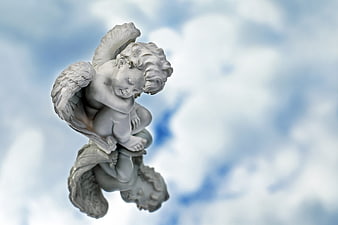 Sleeping angel statue with reflection against cloudy sky