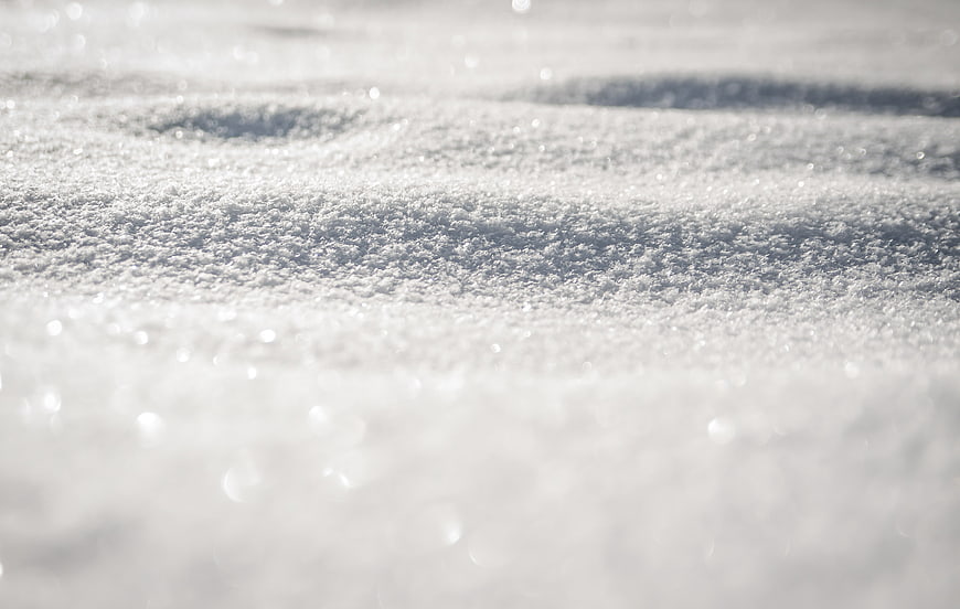Close-up of sparkling frost crystals on snow surface