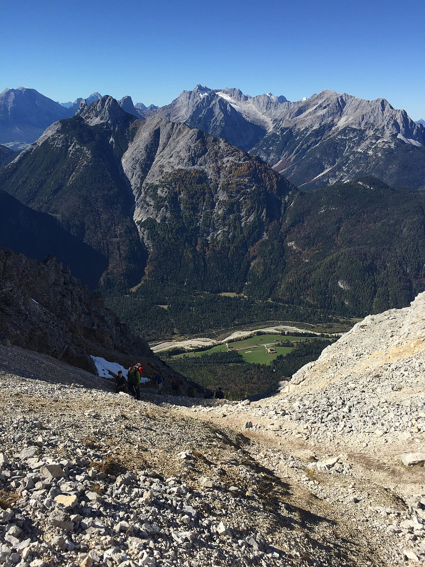 Hikers on Rocky Mountain Trail with Alpine Valley View