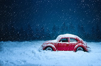 Red Vintage Toy Beetle Car in Snowy Winter Scene
