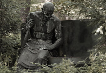 Melancholic Bronze Statue of a Seated Man in a Garden
