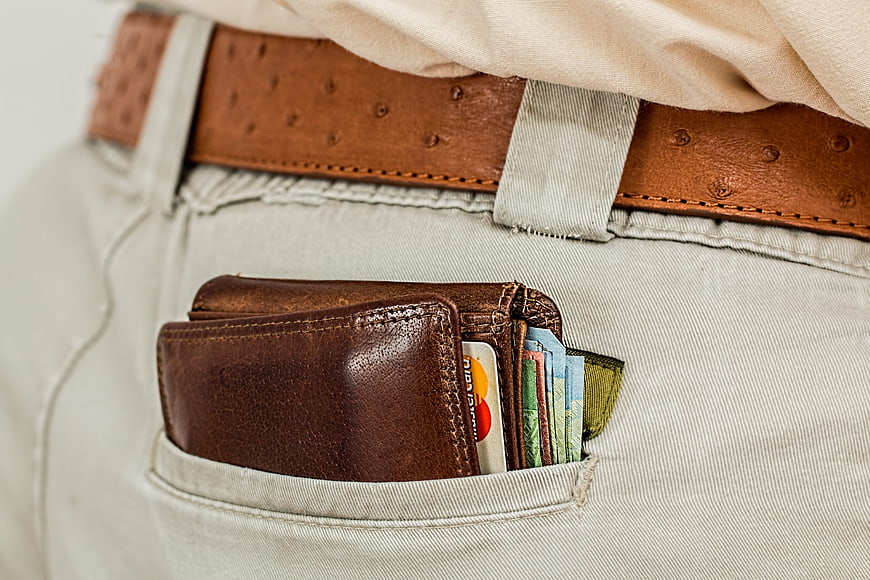 Close-up of leather wallet with cash and cards in pocket