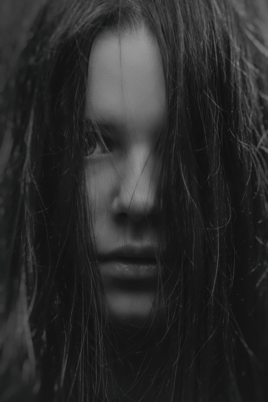 Moody black and white portrait of woman with wet hair