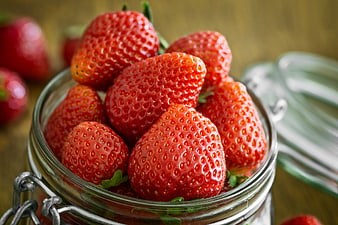 Fresh Red Strawberries in a Glass Jar on Wooden Table