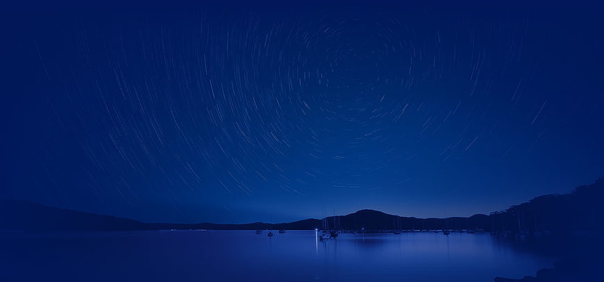 Star Trails Over Calm Harbor Night Sky