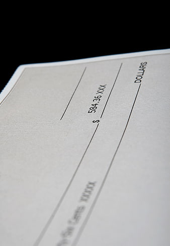 Close-up of a blank check with dollar amount and financial details