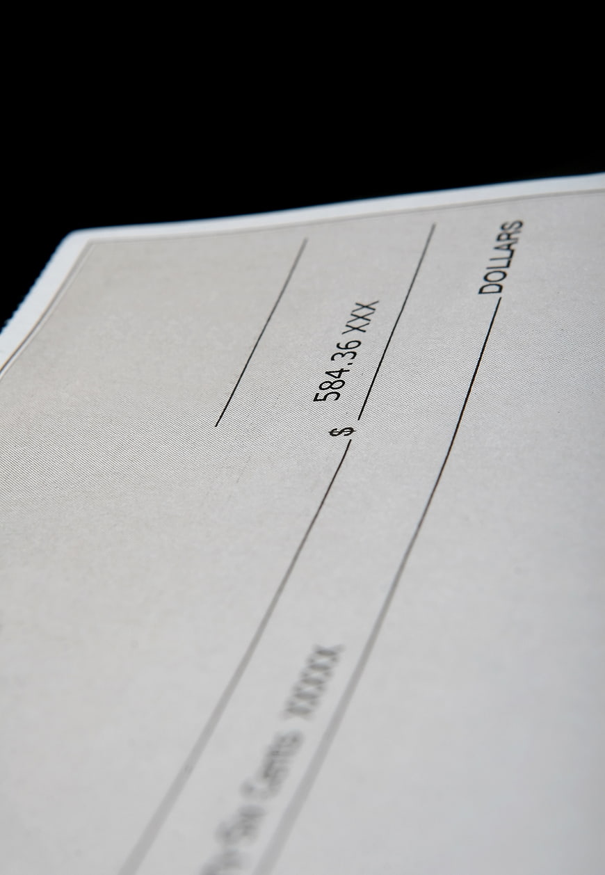 Close-up of a blank check with dollar amount and financial details