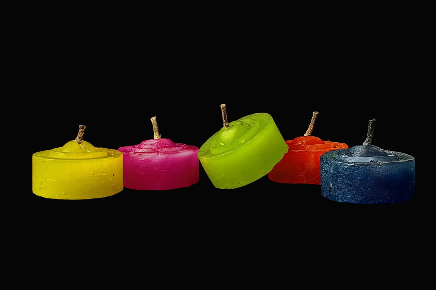 Colorful Tealight Candles on Black Background