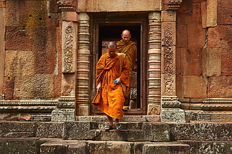 Two Buddhist Monks Descending Ancient Stone Temple Stairs