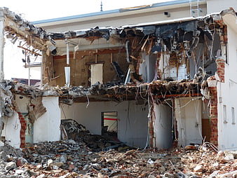 Demolished Residential Building Interior With Exposed Structural Debris And Rubble
