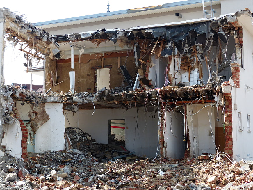 Demolished Residential Building Interior With Exposed Structural Debris And Rubble
