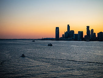 New York City Skyline at Sunset with Boats on Water