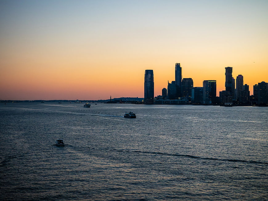 New York City Skyline at Sunset with Boats on Water