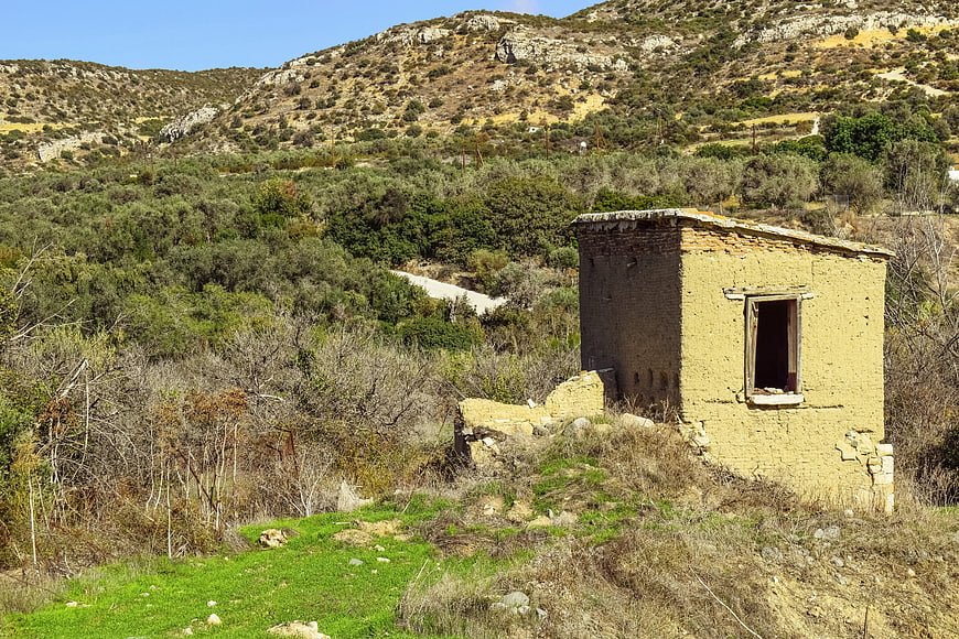 Abandoned yellow stone house ruins in Mediterranean countryside